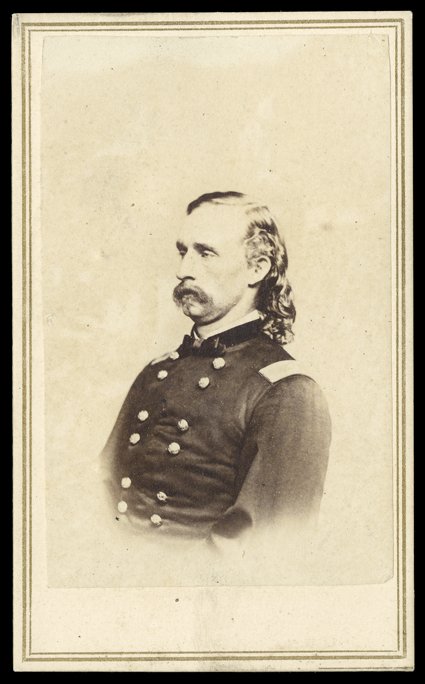 [George Armstrong Custer] Choice Civil War-date carte-de-visite Photograph of Custer by Mathew Brady, published by E. & H.T. Anthony of New York. A ca.1864 image of Custer,
waist-length, in profile facing left. Two-cent orange (R14) revenue stam