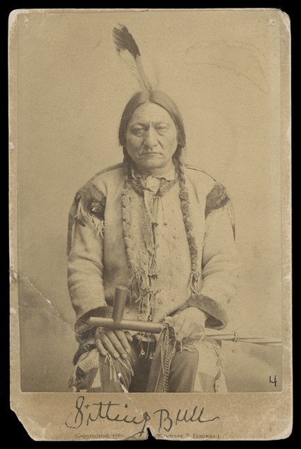 Sitting Bull, Rare cabinet card Photograph Signed on verso by the Sioux war chief who spent his later years as a living legend of the Old West. An image of him seated with a
peace pipe lying across his knees and a printed signature on blank margi